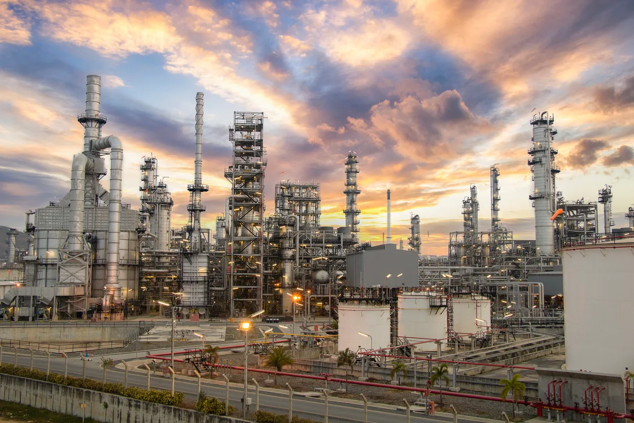 Oil refinery and clouds in sky.